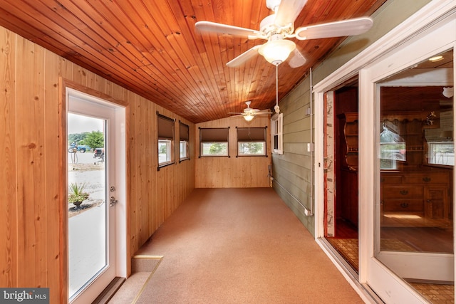 unfurnished sunroom featuring wood ceiling, vaulted ceiling, and ceiling fan