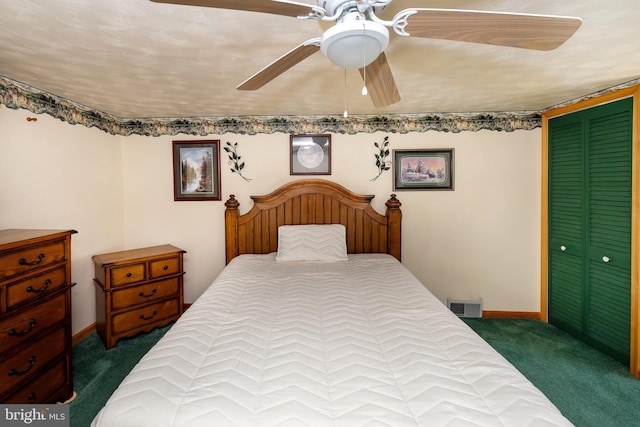 carpeted bedroom with a textured ceiling, ceiling fan, and a closet