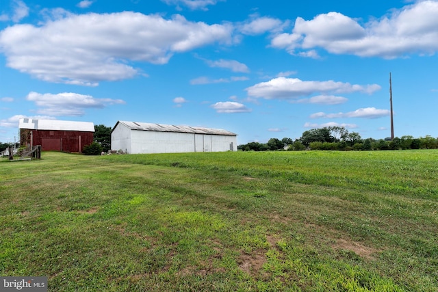 view of yard with a rural view and an outbuilding