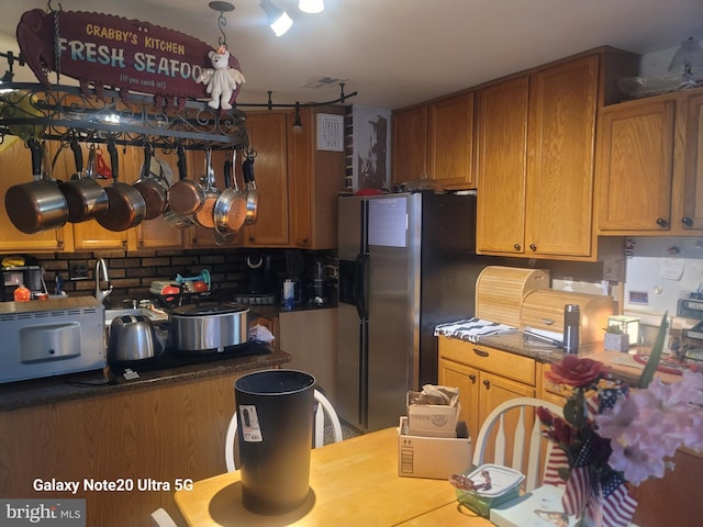 kitchen featuring black refrigerator with ice dispenser