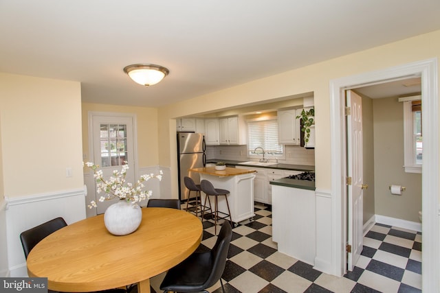 dining room featuring a wealth of natural light and sink