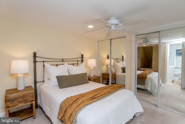 carpeted bedroom with ceiling fan and ensuite bathroom