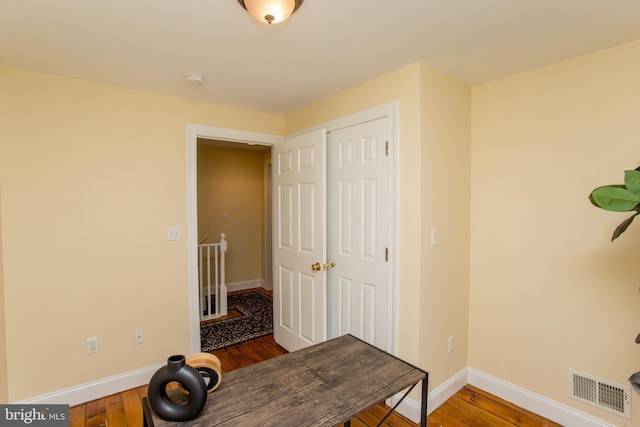 home office with hardwood / wood-style flooring