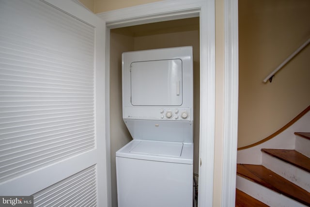 laundry area featuring stacked washer / dryer