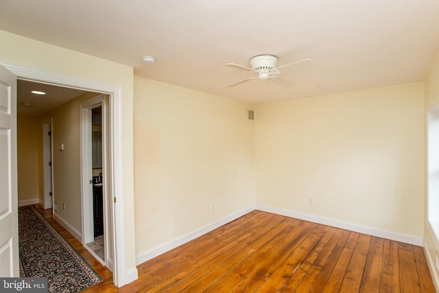 empty room featuring ceiling fan and wood-type flooring