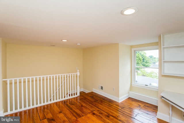 spare room featuring wood-type flooring