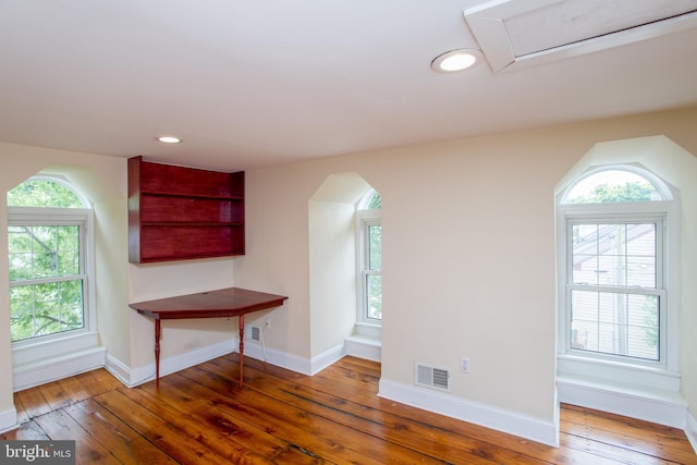 bonus room with dark wood-type flooring