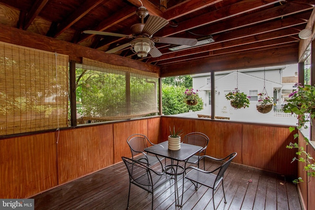 unfurnished sunroom with ceiling fan