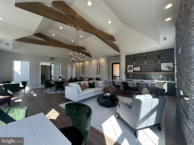 living room featuring an inviting chandelier, dark hardwood / wood-style flooring, beam ceiling, and high vaulted ceiling