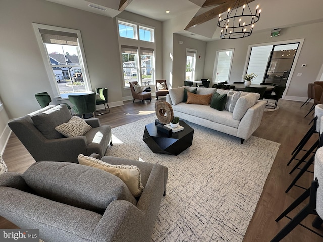 living room with wood-type flooring and a chandelier