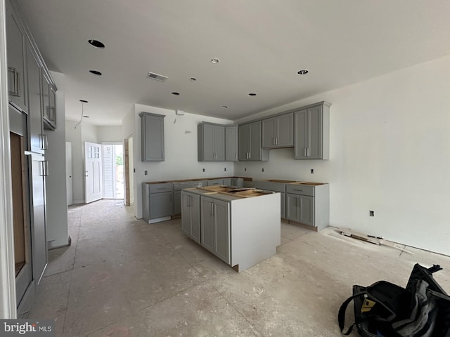 kitchen with a kitchen island and gray cabinets