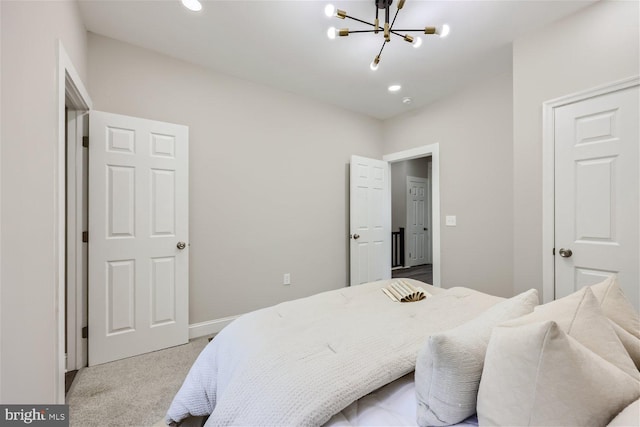 carpeted bedroom with a chandelier