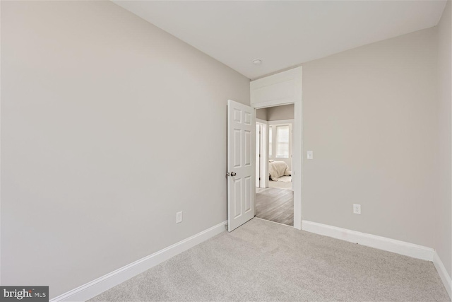 spare room with light colored carpet