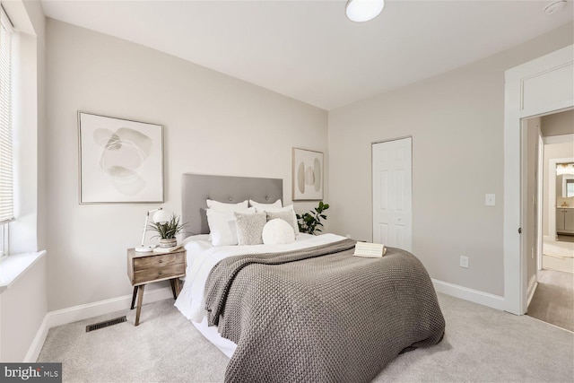 bedroom with light colored carpet