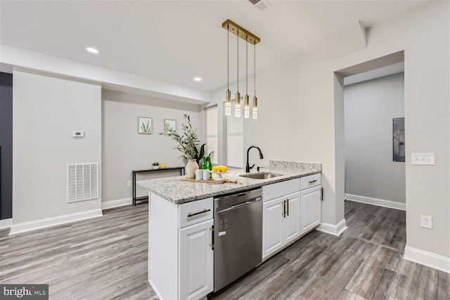 kitchen featuring white cabinetry, sink, hanging light fixtures, light stone counters, and stainless steel dishwasher