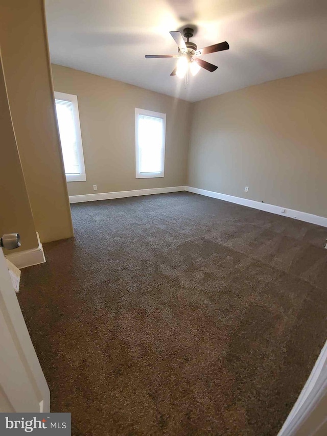 carpeted spare room with ceiling fan