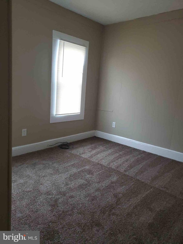 empty room with dark carpet