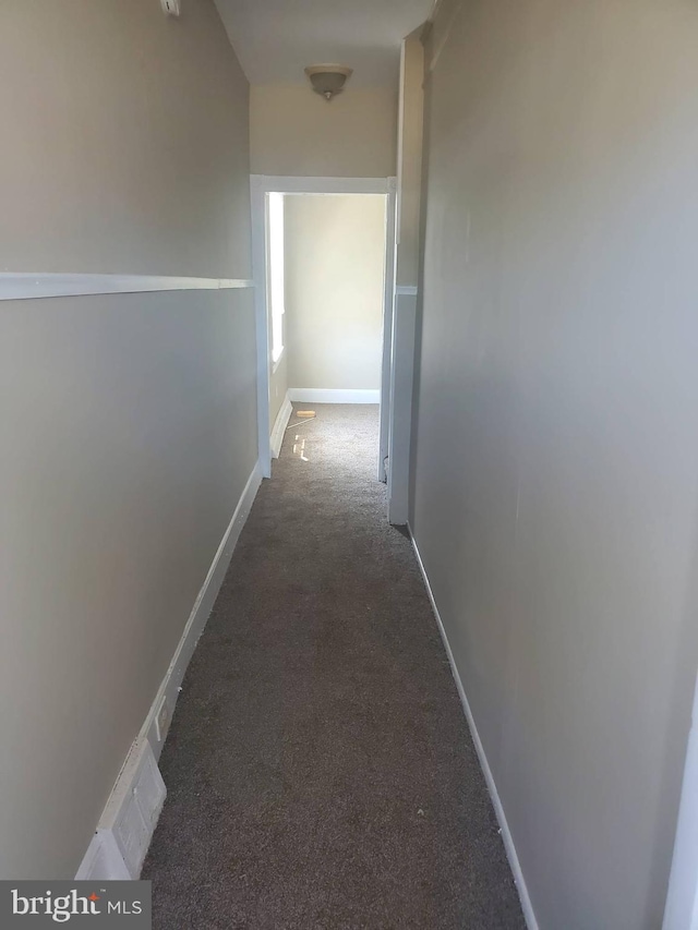 hallway with dark carpet