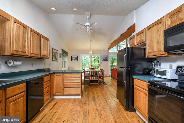 kitchen featuring black appliances, vaulted ceiling, ceiling fan, a textured ceiling, and light hardwood / wood-style floors