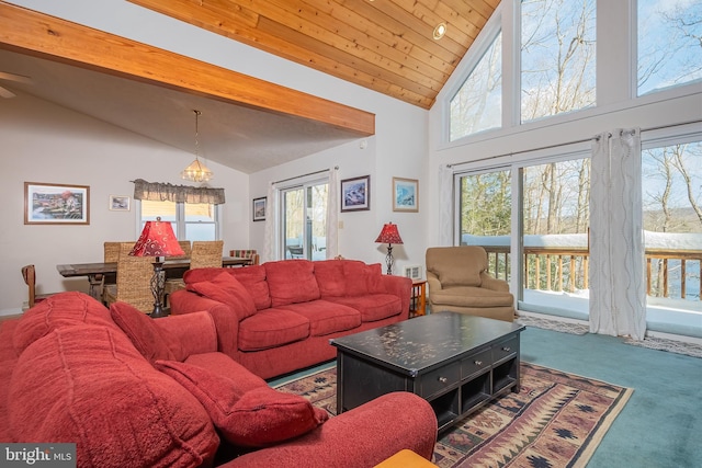 living room with beam ceiling, a towering ceiling, carpet floors, and an inviting chandelier