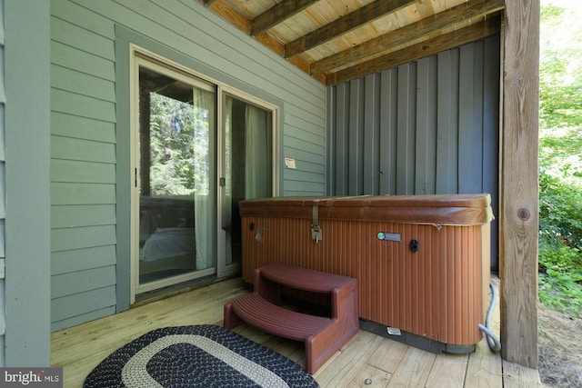 wooden deck with a hot tub