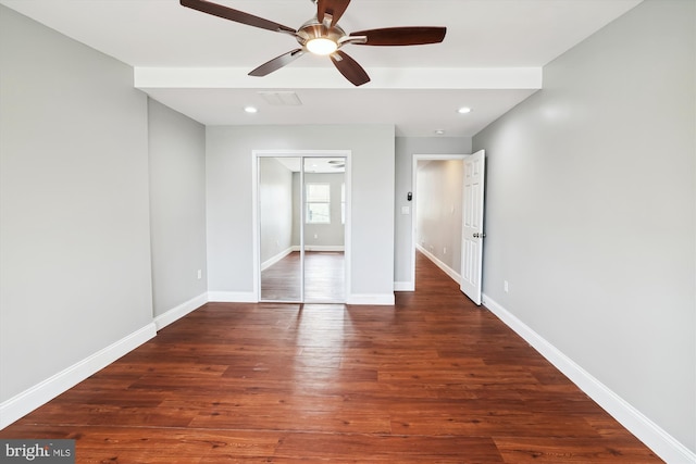 unfurnished bedroom featuring ceiling fan, dark hardwood / wood-style flooring, and a closet