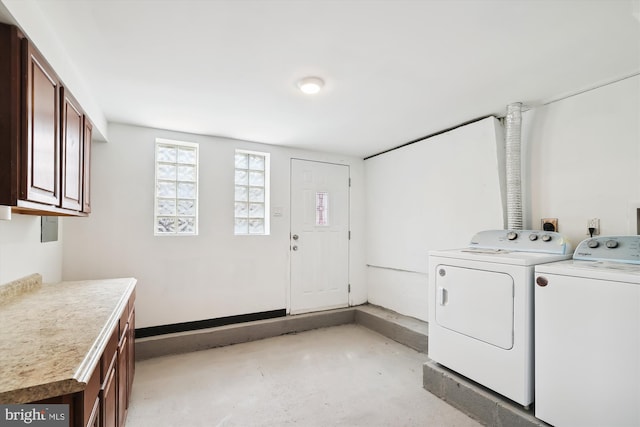 laundry room featuring washer and clothes dryer and cabinets