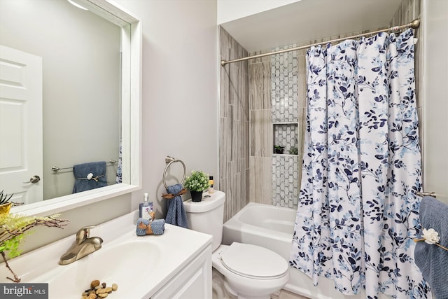 full bathroom with shower / tub combo with curtain, vanity, and toilet