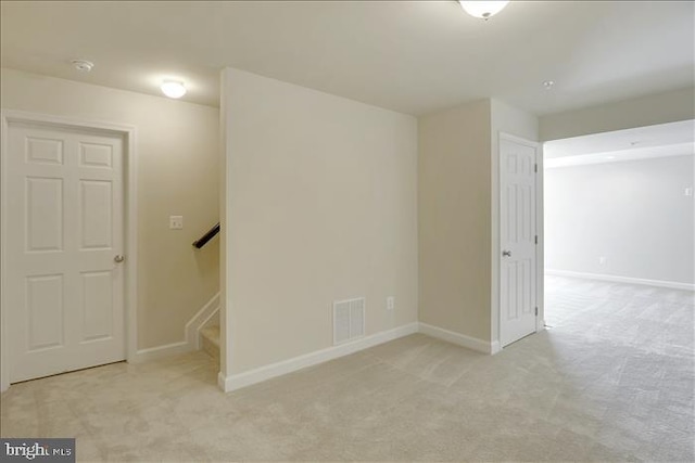 basement featuring light colored carpet