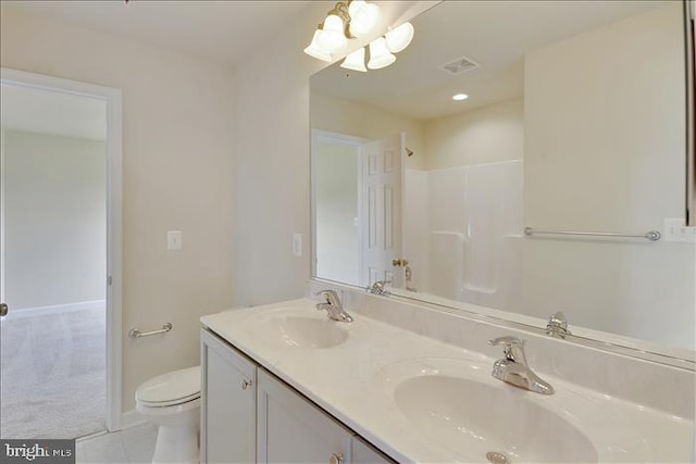 bathroom featuring tile patterned floors, a shower, vanity, and toilet