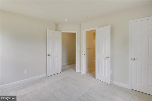 unfurnished bedroom with light colored carpet