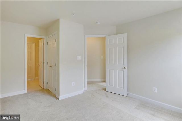 unfurnished bedroom featuring light colored carpet