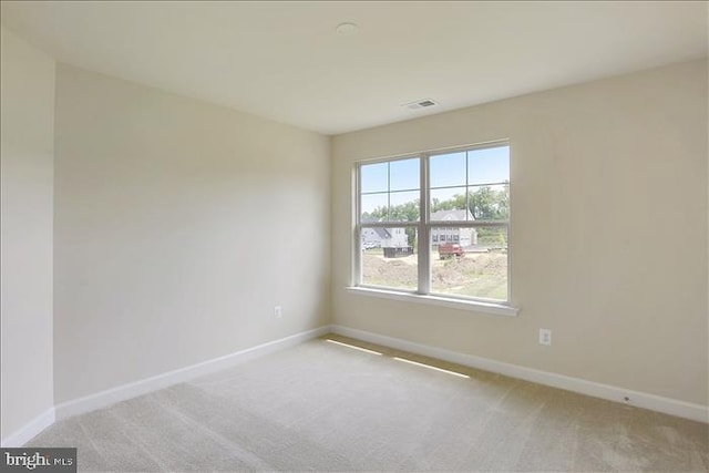 unfurnished room with light colored carpet