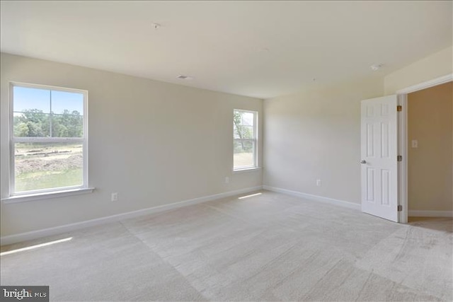 spare room with light colored carpet