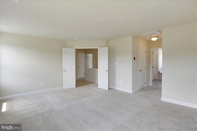 empty room featuring light carpet