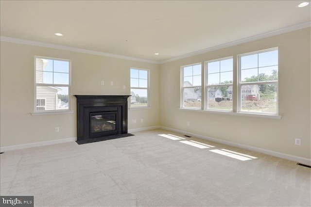 unfurnished living room with light colored carpet and ornamental molding