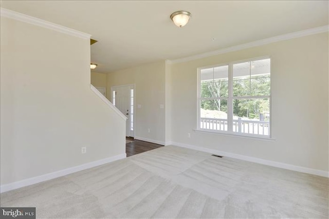 carpeted spare room with crown molding