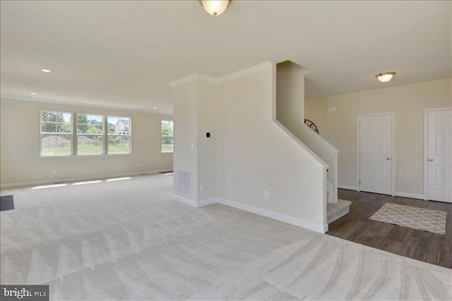 interior space with light colored carpet and ornamental molding