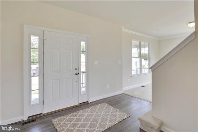 foyer featuring dark hardwood / wood-style floors and ornamental molding