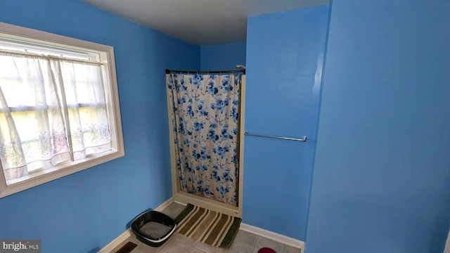 bathroom featuring a shower with shower curtain and tile patterned flooring