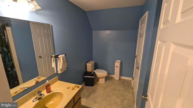 bathroom with vanity, lofted ceiling, and toilet