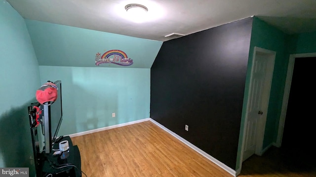 game room featuring hardwood / wood-style flooring and vaulted ceiling