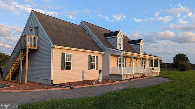 view of home's exterior featuring a lawn and covered porch