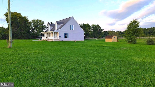 view of yard with a storage unit and a porch