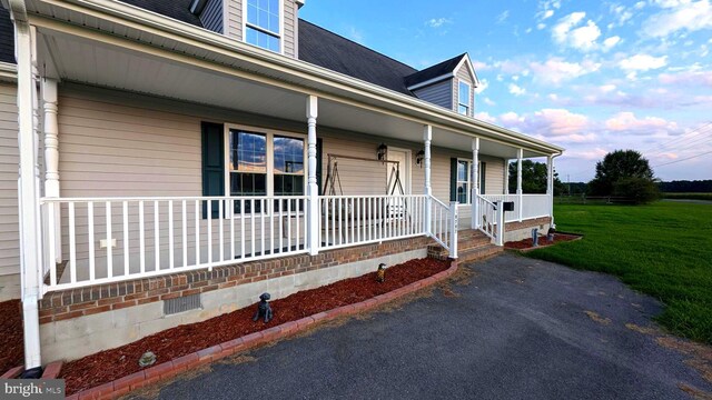 view of front of property with covered porch and a front yard