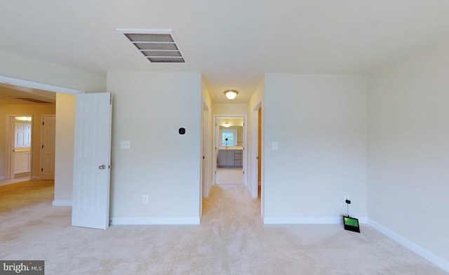 empty room featuring light colored carpet