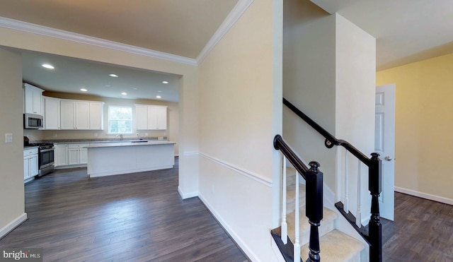 stairs featuring wood-type flooring and ornamental molding