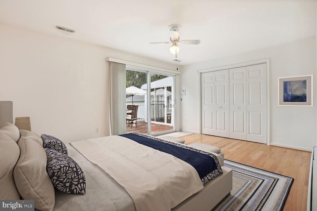 bedroom featuring hardwood / wood-style flooring, access to outside, a closet, and ceiling fan