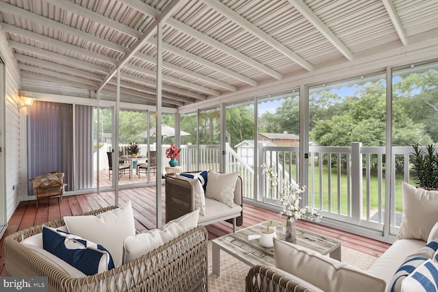 sunroom featuring a healthy amount of sunlight and beamed ceiling