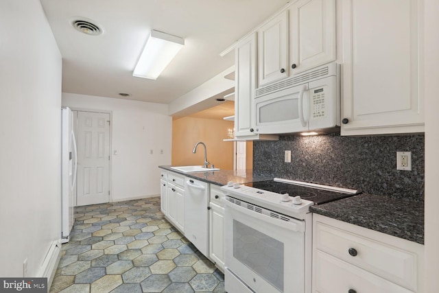 kitchen with decorative backsplash, white appliances, dark stone counters, white cabinets, and sink